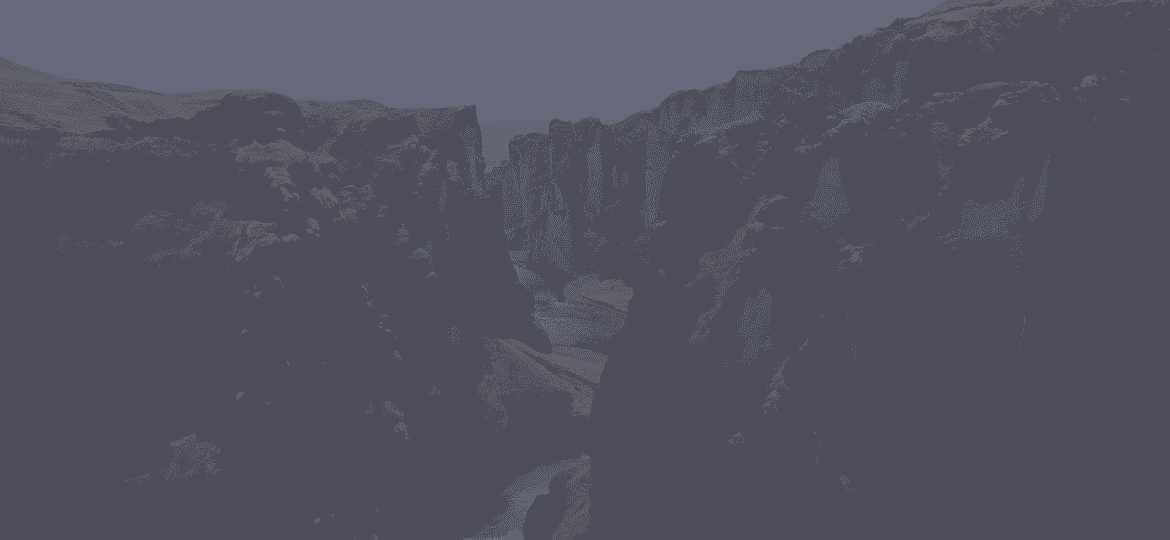 Majestic canyon with rocky cliffs and greenery.