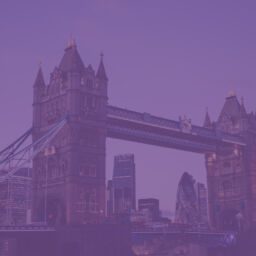 Tower Bridge illuminated in purple hues.