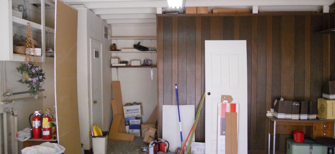 Cluttered garage with storage items and tools.