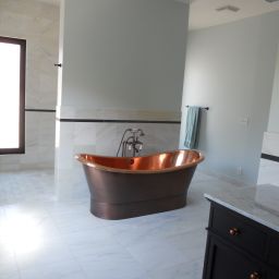 Elegant modern bathroom with copper bathtub.