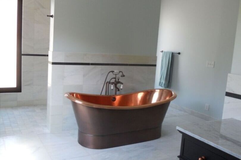 Elegant modern bathroom with copper bathtub.